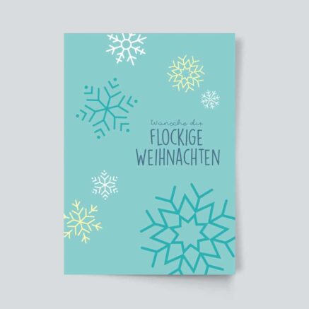 Karte mit dem Text 'Wünsche dir Flockige Weihnachten' und verschiedenen Schneeflocken in verschiedenen Farben.